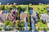 Neighborhood aerial. Pools and docks shown are on neighboring properties and are not included with this rental. Inland canal with fixed bridges and no