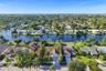 Neighborhood aerial. Pools and docks shown are on neighboring properties and are not included with this rental. Inland canal with fixed bridges and no