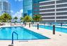 Multi-level outdoor pool deck featuring tile surround, built-in planters, and blue safety railings