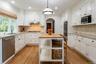 Dine-In Kitchen with custom cabinetry, stainless steel