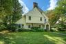 Looking at 49 Beechmont featuring mature landscaping, stucco exterior with wood details.