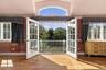 2nd Floor Primary Suite Balcony View down to the Gardens, Terrace & Conservatory Pool