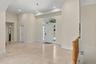 Gracious Entry with a walk in closet, powder room and a huge coat room on the way down the hall to 1st Primary Suite.