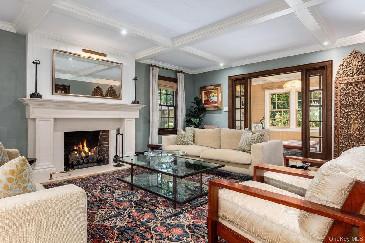 Formal Living Room Featuring coffered ceilings, recessed lighting and fireplace.