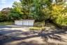 4 car detached garage and driveway that accommodates many cars.