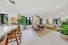 Open-concept interior featuring large-format tile flooring, recessed lighting, and multiple windows with black trim