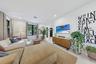 Neutral interior space featuring high ceilings, black-framed multi-pane windows, and light-toned flooring