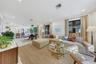 Open-concept interior featuring light-toned flooring, recessed lighting, and expansive windows with black frames
