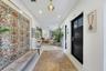 Entryway featuring a black multi-panel door with glass inserts, recessed lighting, and a pendant fixture with a metallic finish