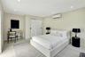 Neutral-toned interior featuring recessed lighting, a wall-mounted climate control unit, and double sliding closet doors