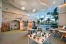 Floor-to-ceiling windows, custom built-in wall alcoves, decorative wall mural, sculpted tray ceiling with recessed lighting, and suspended cloud-style
