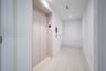 Private elevator access featuring matte-finish doors, recessed ceiling lighting, and large-format stone-look floor tiles