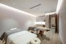 Interior room featuring wood-finish flooring, recessed ceiling lighting with perimeter cove illumination, and built-in cabinetry with integrated under