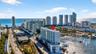 Aerial perspective of high-rise building situated on a waterway with prominent proximity to the coastline