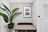 White louvered doors and a wall-mounted programmable thermostat