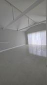 Vaulted ceiling featuring exposed structural beams, high-gloss tile flooring, and floor-to-ceiling windows
