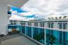 Private balcony featuring a glass-panel railing and concrete flooring
