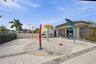 Splash pad featuring integrated water spray fixtures, concrete surfacing, paver patio, and metal perimeter fencing