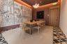 Geometric patterned flooring, recessed cove lighting, suspended multi-globe chandelier, and wood-finish door with matching frame