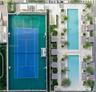 Recreational amenities featuring a multi-sport court with basketball and tennis markings, two rectangular swimming pools, and landscaped areas with pa