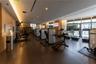 Fitness center featuring wood-finish flooring, floor-to-ceiling windows, recessed ceiling lighting, and perimeter wall-paneling