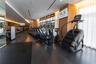 Fitness center featuring dark wood-finish flooring, floor-to-ceiling windows, full-length wall mirrors, and recessed ceiling lighting