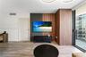 Interior featuring wood-finish flooring, floor-to-ceiling slatted wood wall paneling, and an expansive sliding glass door system