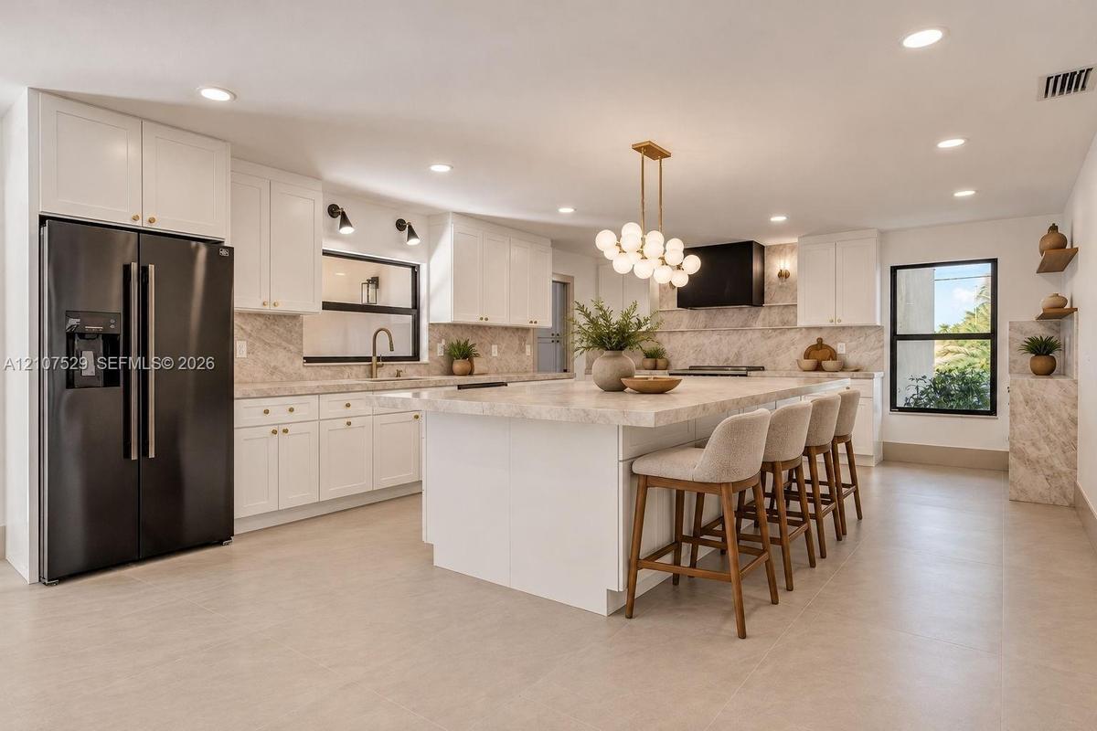 Sliding glass wall, recessed lighting, neutral interior palette, and a private patio enclosure