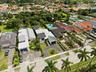 Expansive residential grounds featuring two inground swimming pools, manicured lawn, established perimeter hedging, and mature trees