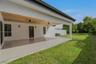 Covered patio featuring a wood-plank ceiling, large-format tile flooring, recessed lighting, ceiling fans, and sliding glass doors