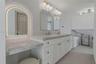 Interior space featuring large-format tile flooring, multi-panel sliding glass doors, recessed lighting, and a drum-style ceiling fixture