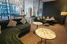 Common area featuring decorative metal room dividers, arched architectural alcoves, and patterned flooring