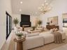 Vaulted ceiling, floor-to-ceiling windows, matte black linear fireplace, and tiered metal chandelier