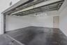 Multi-car garage featuring a concrete floor, finished white walls, and a hexagonal LED ceiling fixture