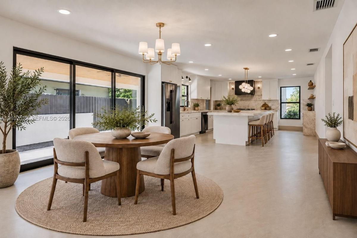 Neutral-toned tile flooring, recessed lighting, industrial-style drum ceiling fan with integrated lighting, and high-contrast window frames