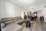 Open floor plan featuring wood-finish flooring, recessed lighting, modern circular halo chandelier, built-in wet bar with cabinetry, and kitchen with 