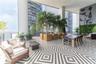 Covered outdoor terrace featuring geometric patterned floor tiling, integrated vertical greenery, and built-in structural columns