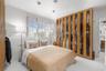 Built-in floor-to-ceiling wood cabinetry with glass panel doors, interior shelving, and recessed ceiling lighting