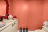 Custom vanity with an integrated basin, countertop, and dark-finished hardware
