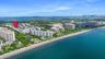 Aerial perspective featuring coastal proximity, shoreline, and metropolitan skyline