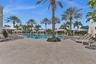 Large outdoor swimming pool with integrated spa and surrounding paver deck
