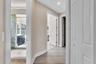 Hallway featuring wood-finish flooring, recessed lighting, and crisp white trim