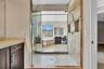 Luxurious primary bathroom featuring a spacious walk-in shower with frameless glass enclosure, dual showerheads, and geometric tile flooring