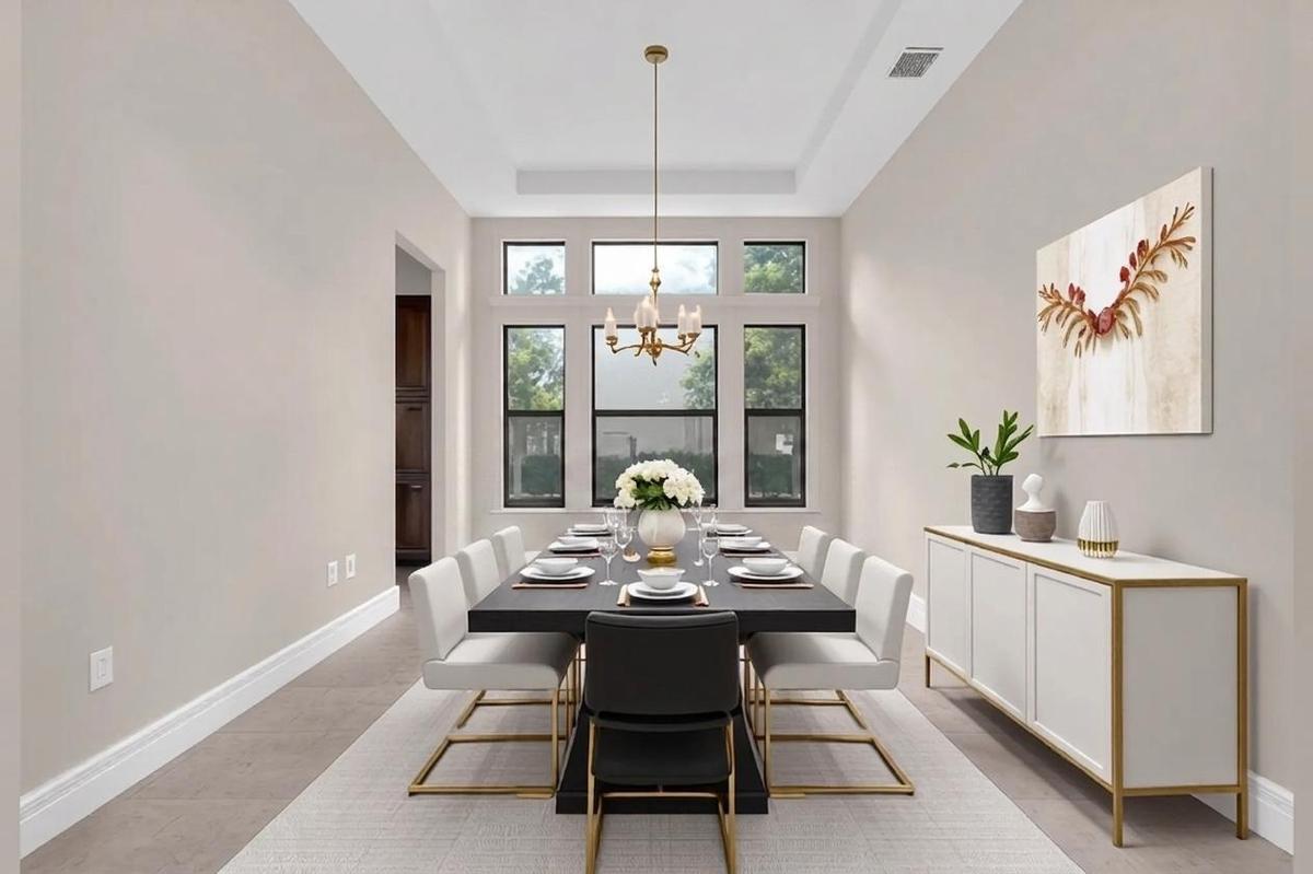 Dining area featuring a coffered ceiling, a multi-pane window configuration, and tile flooring