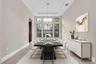 Dining area featuring a coffered ceiling, a multi-pane window configuration, and tile flooring