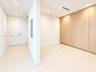 Floor-to-ceiling wood-finish cabinetry, recessed lighting, and wood-finish flooring