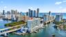 High-rise waterfront property featuring glass-front balconies, integrated marina boat slips, and panoramic coastal and skyline exposure