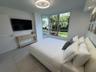 Bay window with multi-pane glass, recessed ceiling lighting, circular flush-mount light fixture, and light-toned flooring