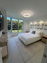 Large bay windows, recessed ceiling lighting, circular modern ceiling fixture, and light-toned flooring
