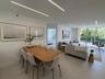 Open-concept interior featuring linear recessed lighting, large-format tile flooring, and floor-to-ceiling glass sliding doors